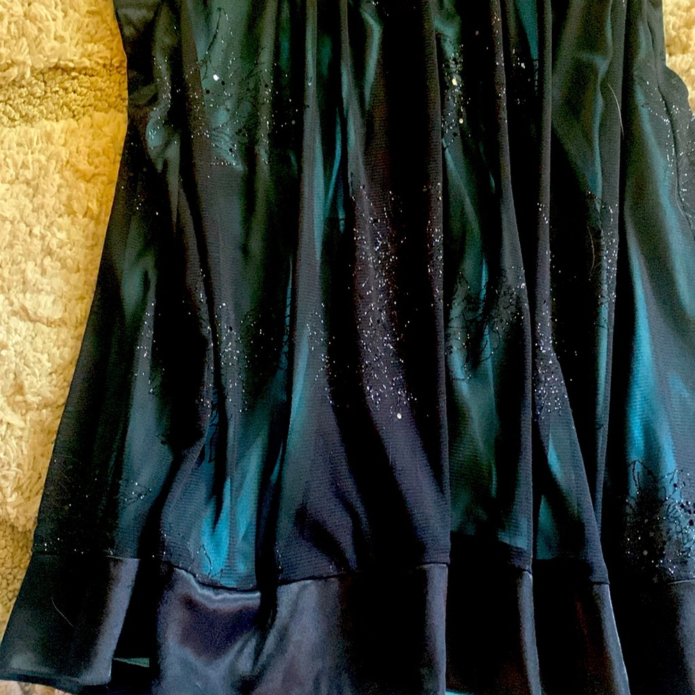 A beautiful mine black prom dress top has sparkly glitter on top